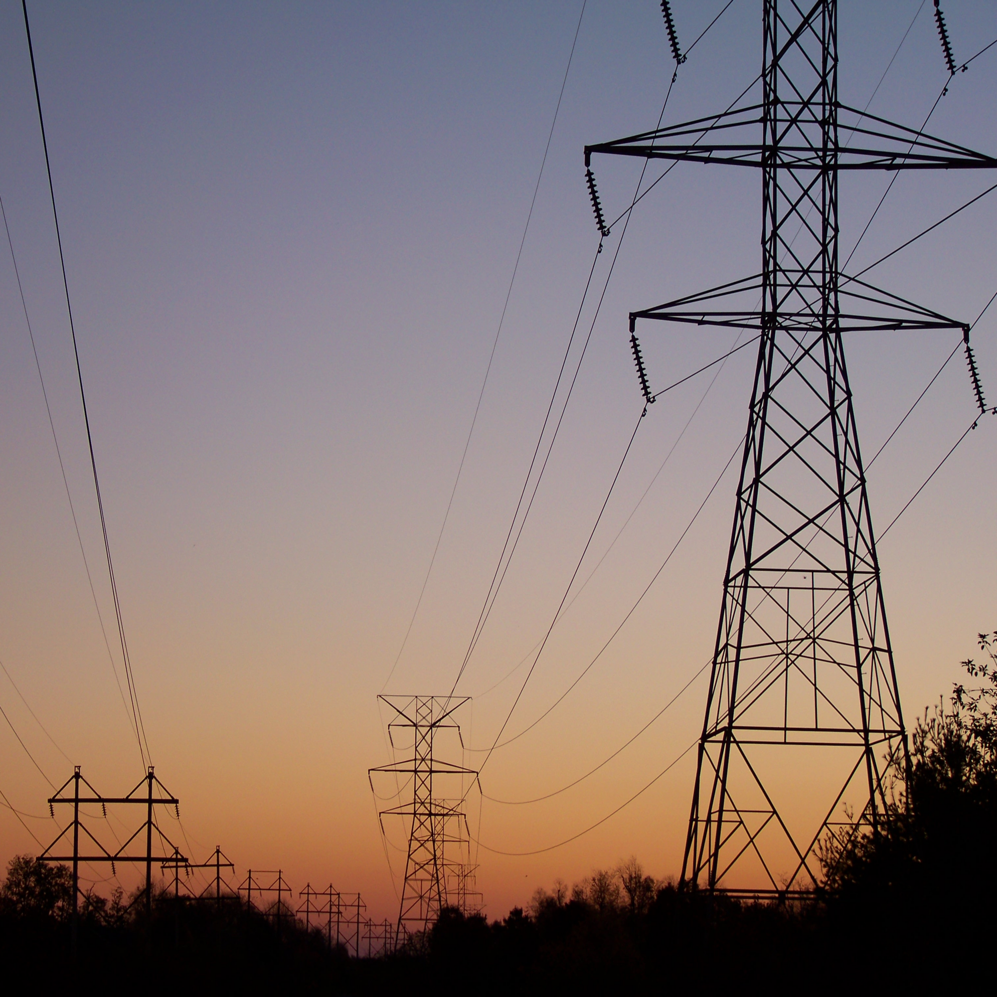 transmission lines with sunset in background